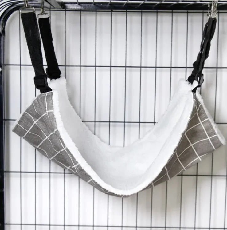 Installation du hamac à chat suspendu à l'intérieur d'une cage grâce aux sangles réglables