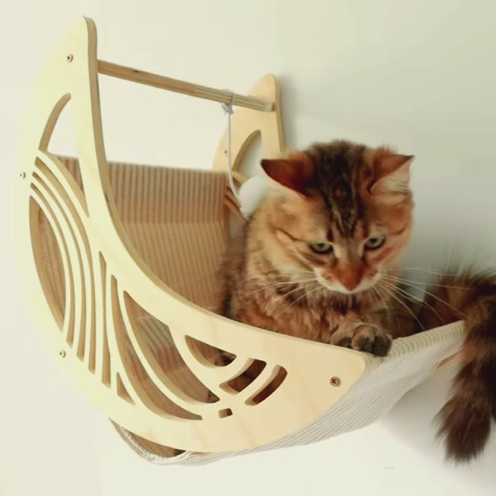Panier mural chat design en bois avec un chat confortablement installé dans son couchage suspendu